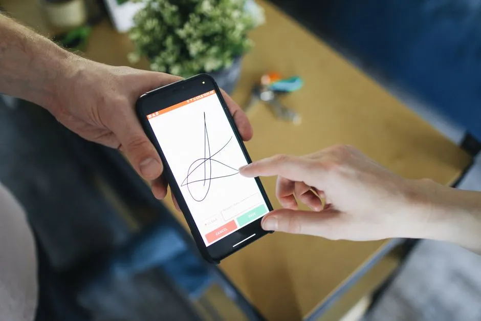 Signature au doigt sur l'écran d'un smartphone